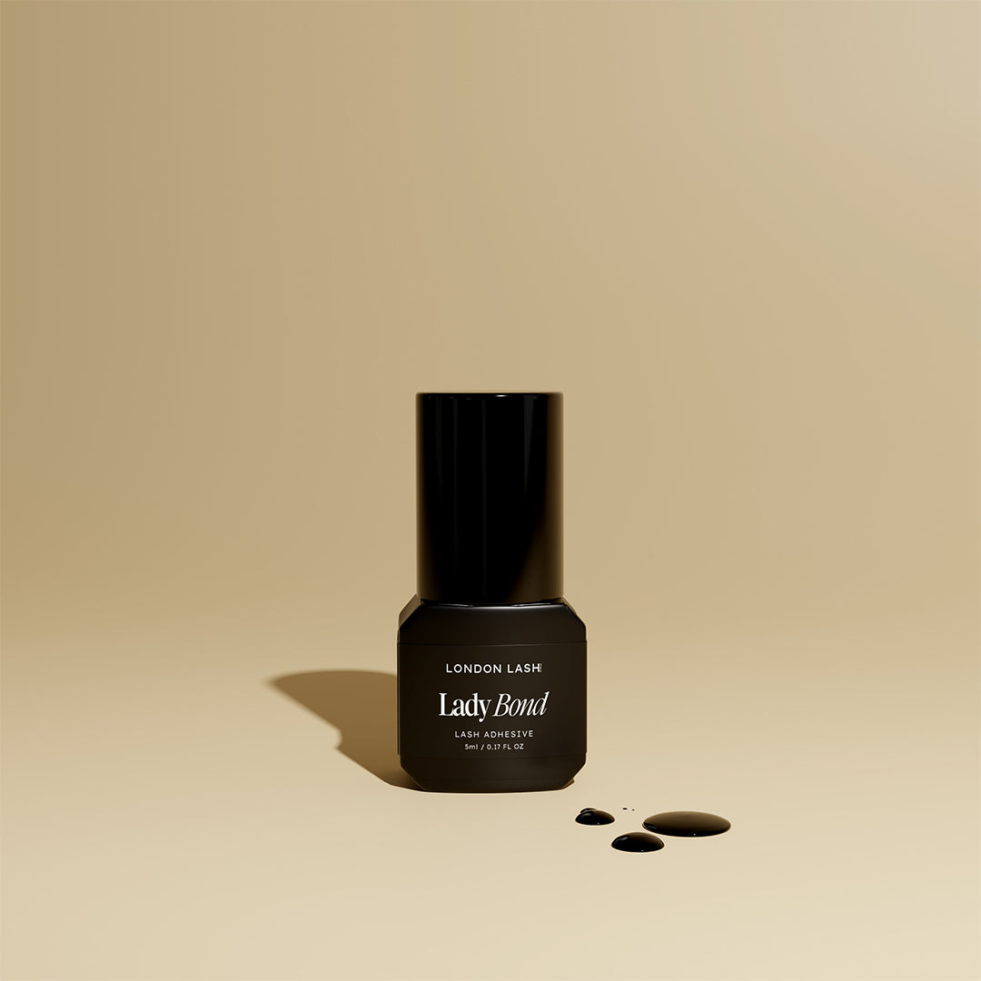 Black bottle of Lady Bond adhesive on a beige background